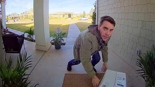 Securelite footage of a man grabbing a package